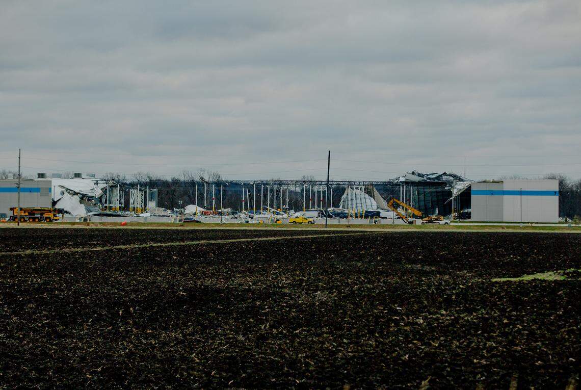 Workers attempt to clear debris as part of a search and rescue operation on Saturday, Dec. 11, 2021, at an Amazon Distribution Hub in Edwardsville, Illinois. Violent storms, some producing tornado activity, ripped through the Midwest on Friday night, killing at least two in the warehouse.