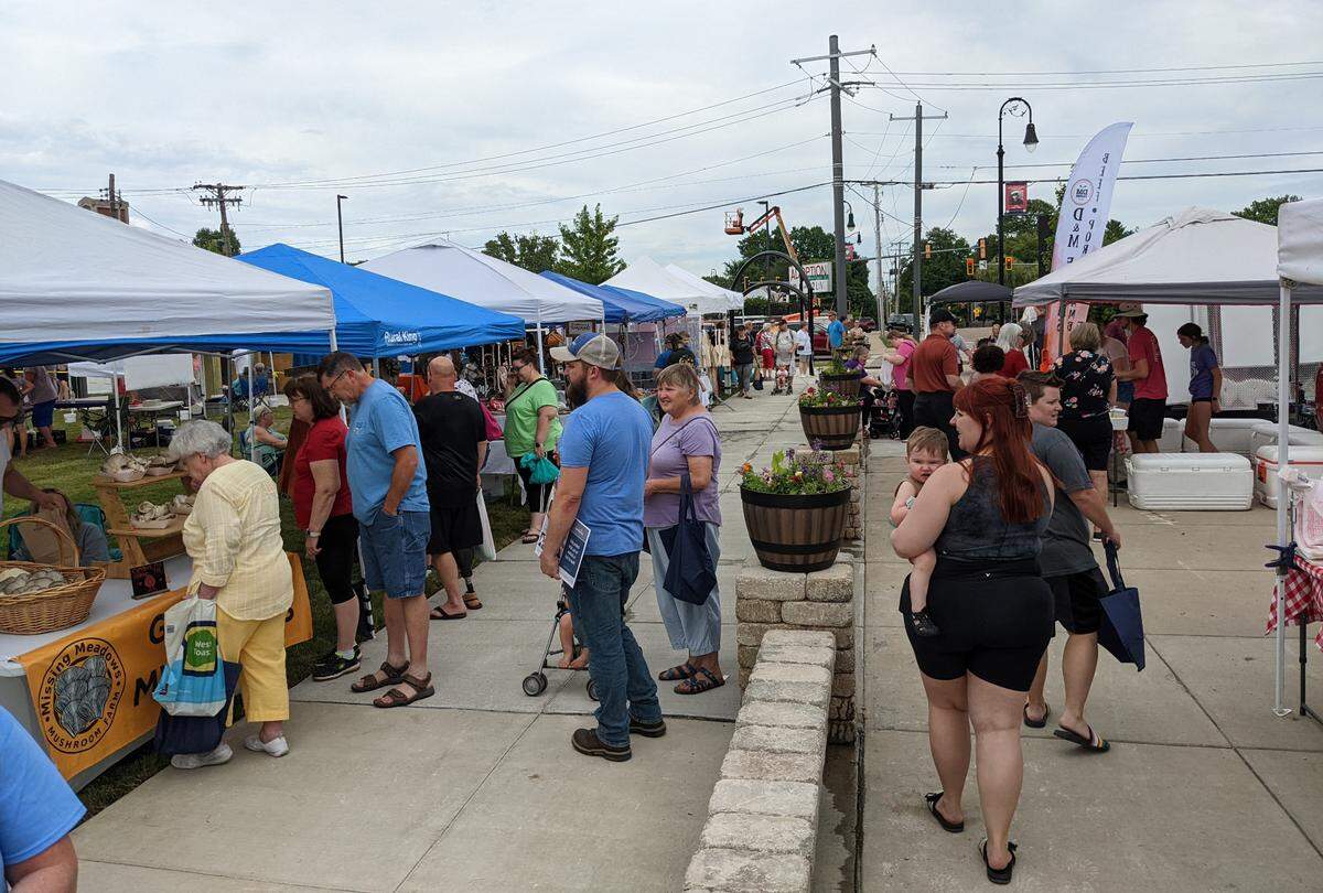 The early crowd at the inaugural Herald Square Farmers Market in Collinsville