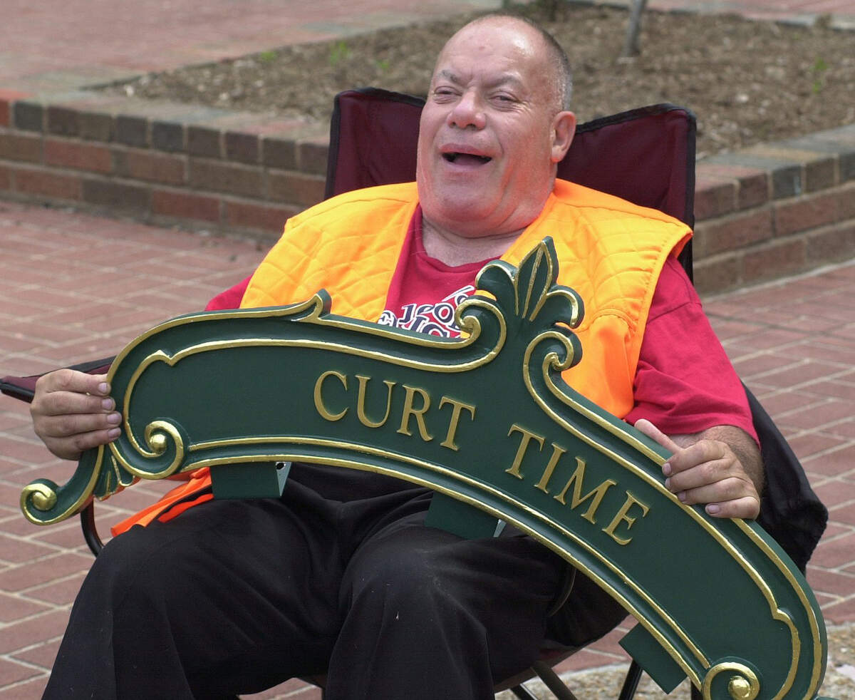 Curt Weisenstein laughs while holding a sign that says “Curt Time” in this 2006 BND file photo. Curt was known for always having the exact time of day and for helping others set their clocks correctly. Two faces of the four-face clock will have these signs, the other two faces say “Belleville Square.”