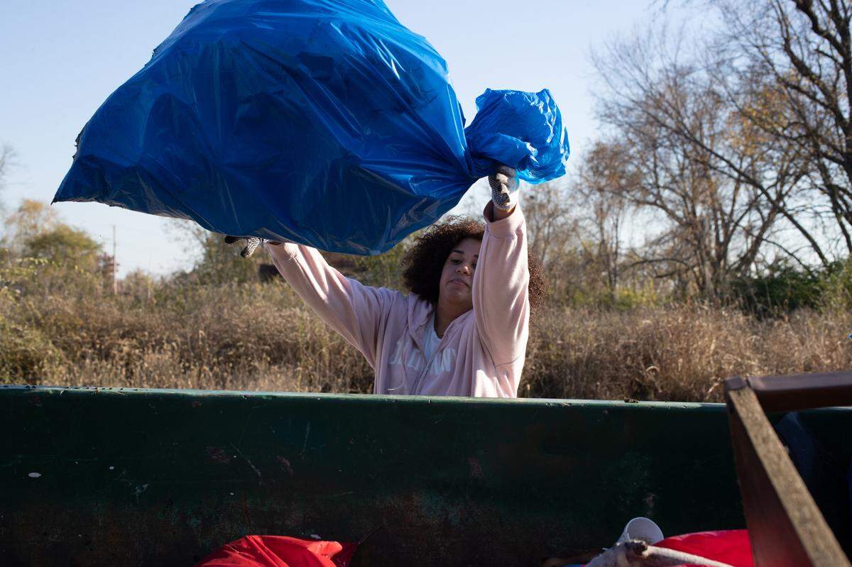 Volunteers carried around trash bags to pick up the mounds of waste at the dump site, eventually filling five dumpsters.