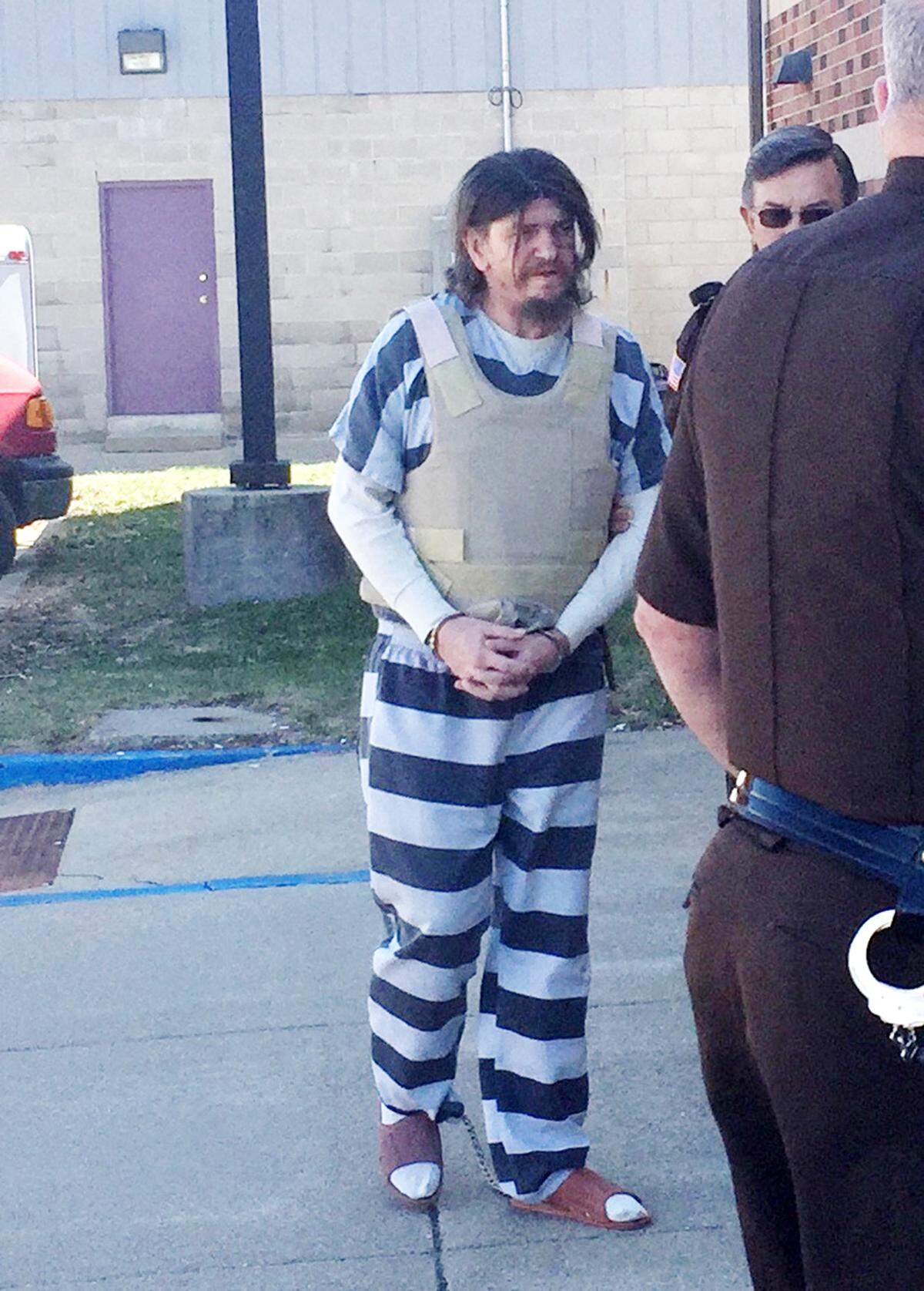 Glenn Ramey, escorted by law enforcement officers, outside the Richland County court house Thursday morning. Ramey was sentenced to 60 years in prison for the sexual assault of an 8-year-old girl in 2016.