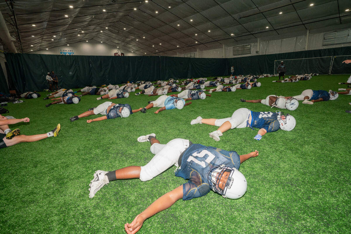 Players from Belleville East warm up at Belleville District 201’s CAVE on Wednesday. Multiple schools in the metro-east are forced to move practices indoors or reschedule games due to an excessive heat and humidity.