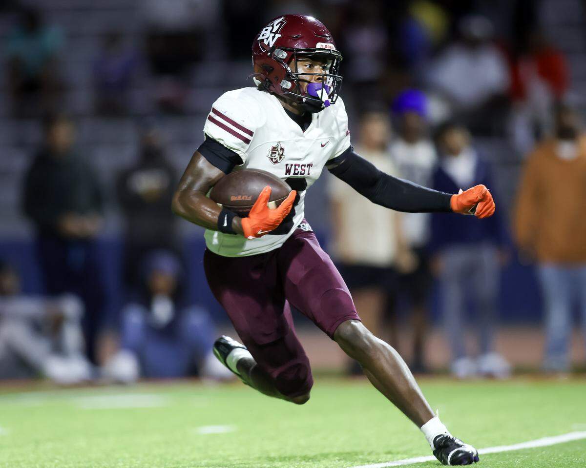 Belleville West's Nicholas Hankins carries against East St. Louis Friday.