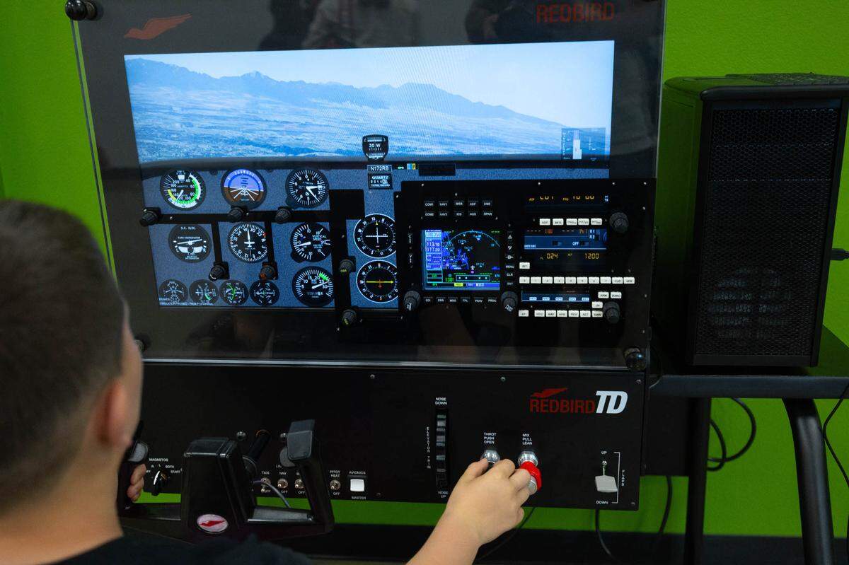 A child plays on a flight simulator during the CAVE’s open house for its newest addition.