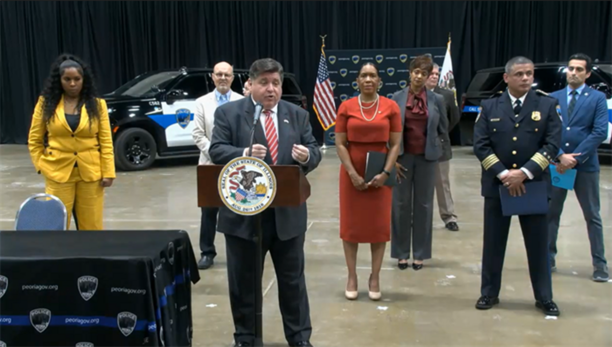 Gov. J.B. Pritzker takes questions at a news conference after signing a public safety measure Tuesday in Peoria. As part of House Bill 4736, police departments in four communities in Illinois will be part of a co-responder pilot program that aims to send social workers and mental health professionals on law enforcement calls.
