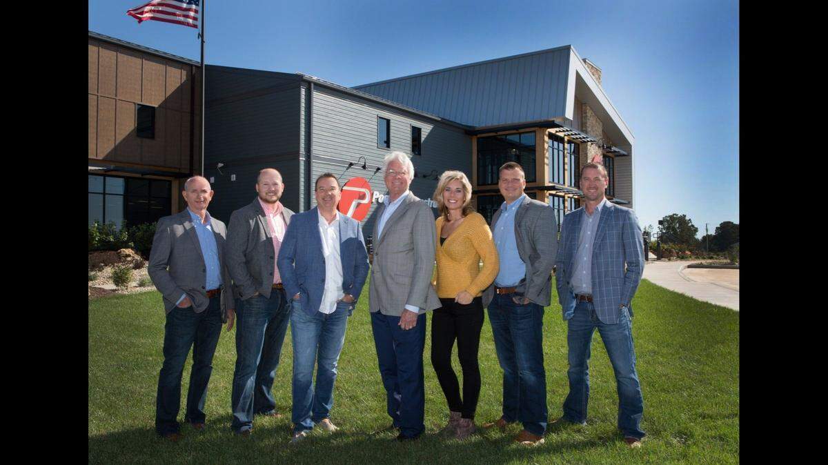 Poettker Construction executives stand in front of their new Breese headquarters in 2019. They are, left to right, Tom Albers, Jon Carroll, Keith Poettker, Charles Poettker, Kim Luitjohan, Ryan Poettker and Kevin Poettker.