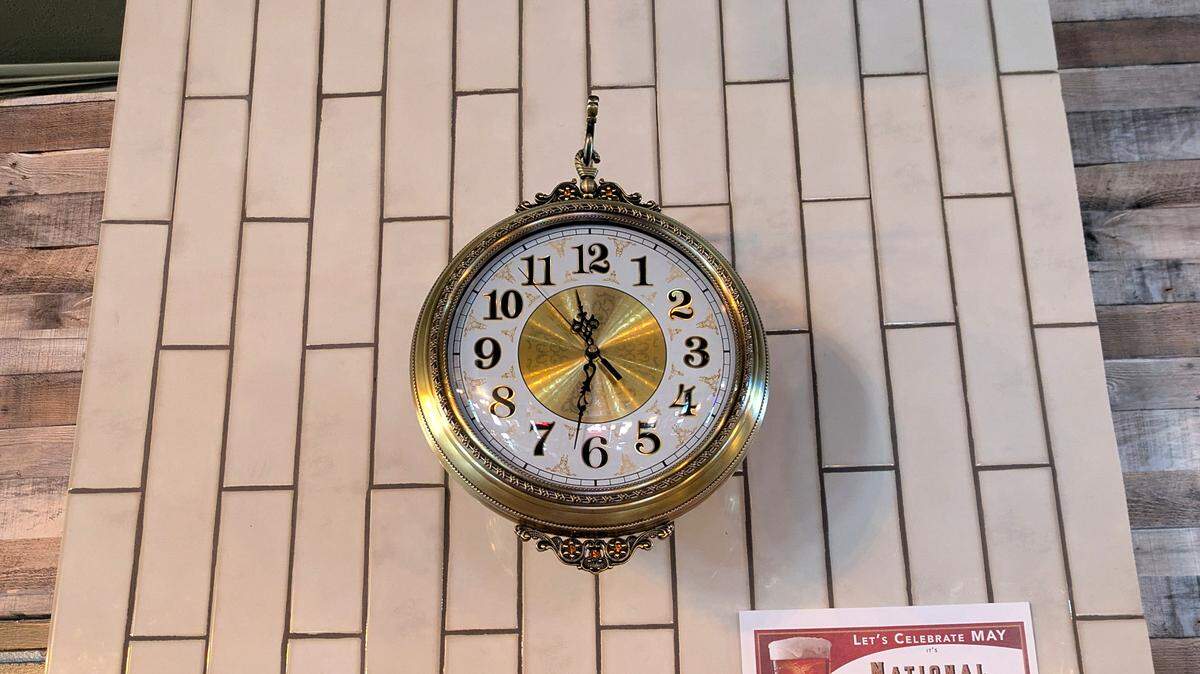 A brass clock is one of the many decorative wall pieces at The Roost in Smithton.