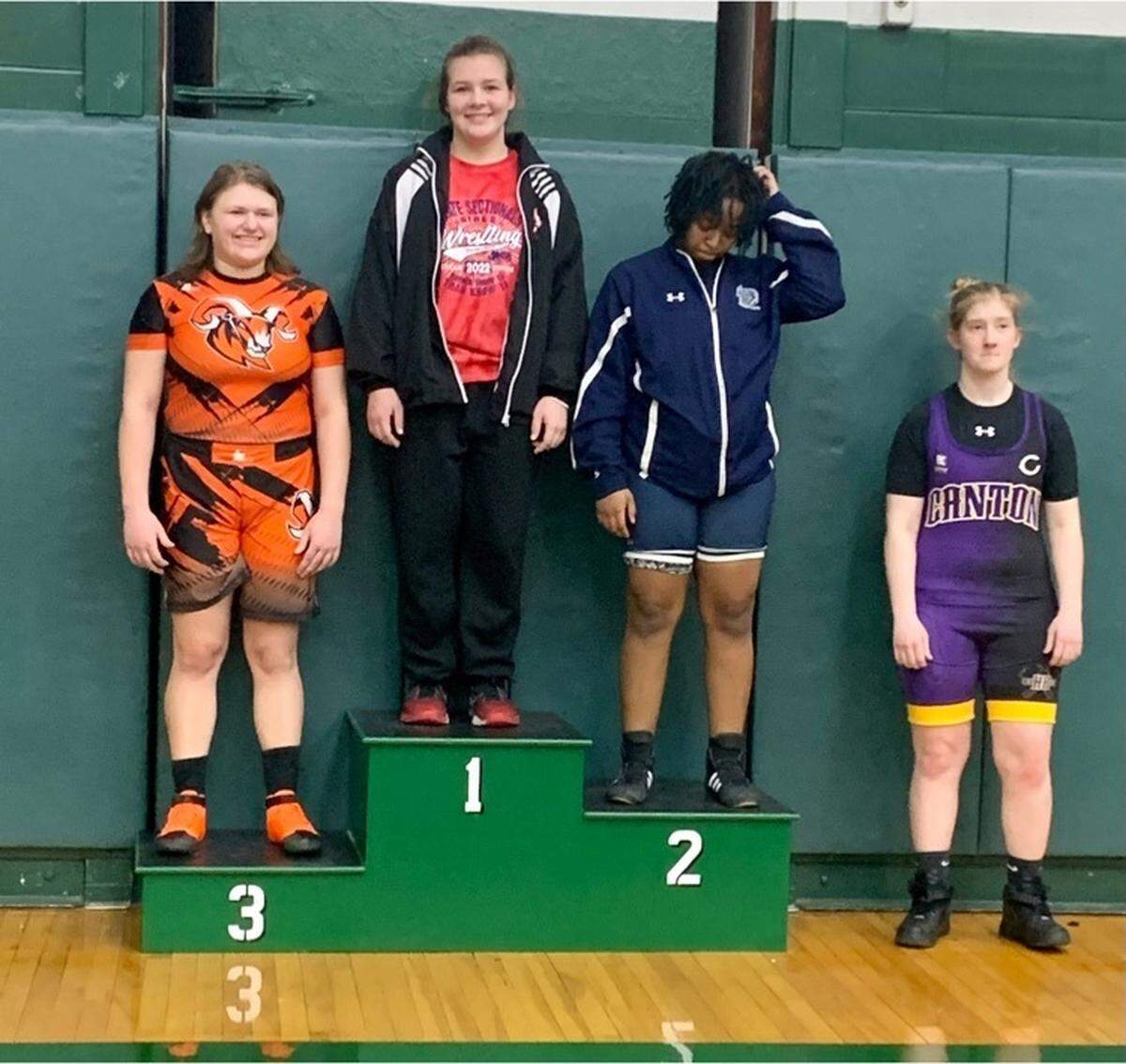 August Rottmann of Highland, top left, is on the medal stand after claiming to girls 170-pound sectional championship at the IHSA girls sectional tournament at Peoria Richwood High School on Saturday, Feb. 12.