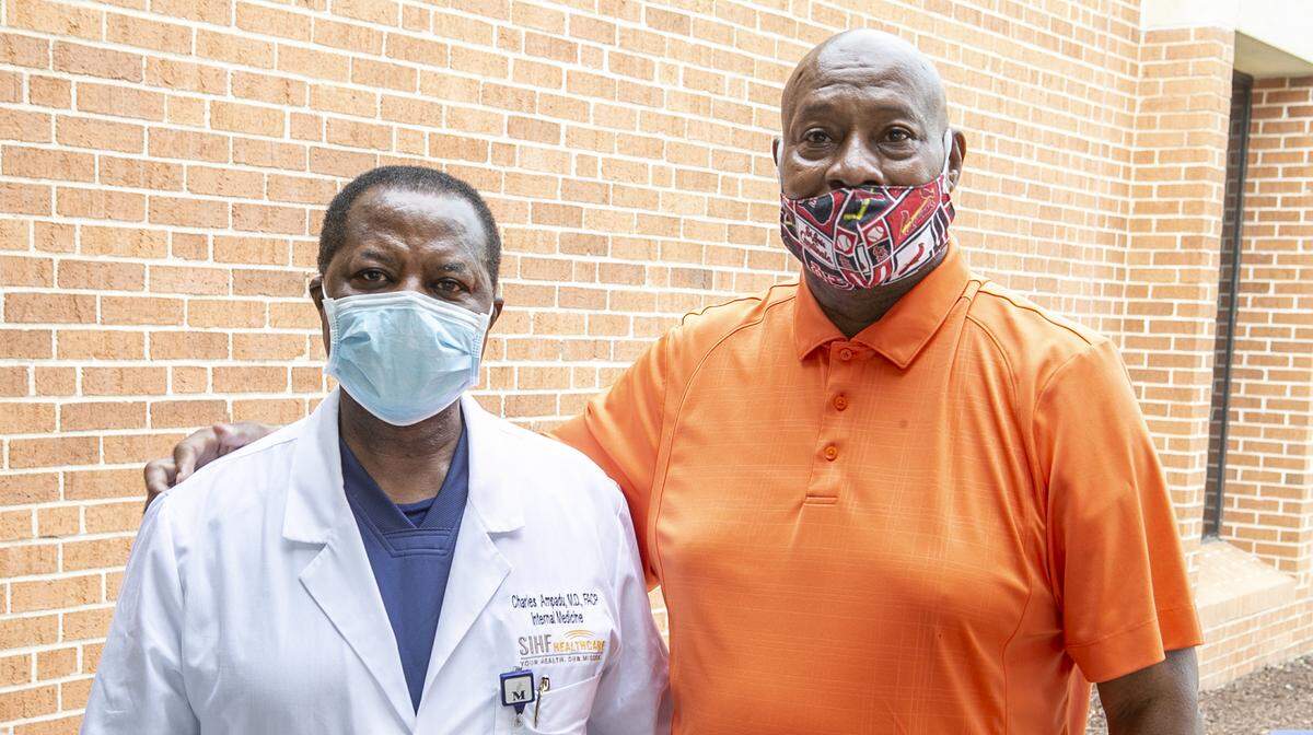Kevin Anderson, right, stopped by Memorial Hospital in Belleville on Friday to thank Dr. Charles Ampadu and other staff for getting him through COVID-19. He was released May 1.