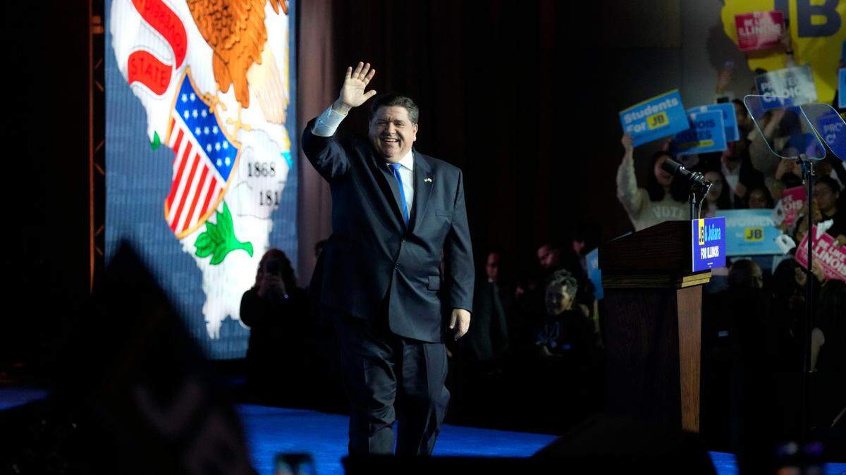 Gov. J.B. Pritzker waves to supporters as he declares victory over GOP challenger Darren Bailey, Tuesday, Nov. 8, 2022, in Chicago. (AP Photo/Nam Y. Huh)