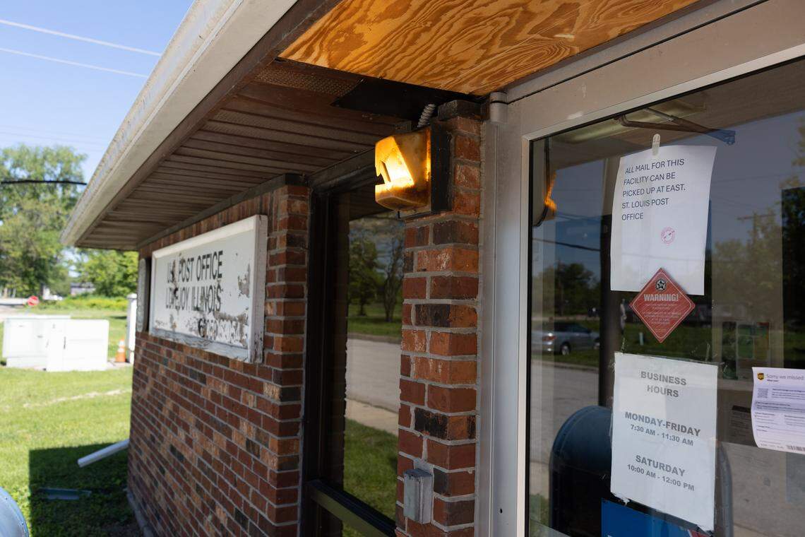 A sign on the door of the Brooklyn post office dated April 16, 2026, directs locals to pick up their mail in East St. Louis.