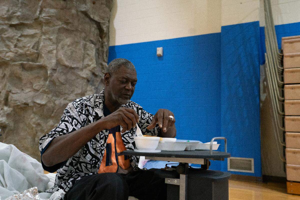 Daniel Gibson, 66, eats food supplied by the American Red Cross at the Cahokia Heights Fitness and Community Center on Oct. 26, 2023, after being displaced from an apartment due to a fire the day before.