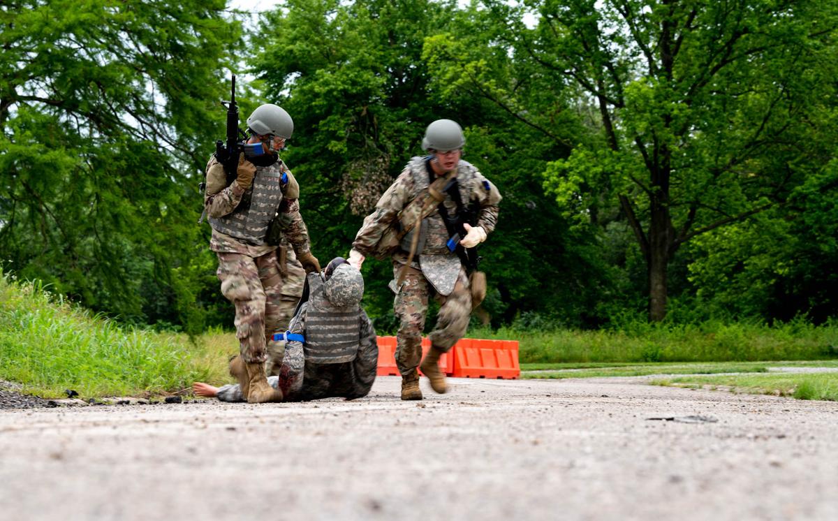 From left, Senior Airman Christopher Lee, 375th Operations Support Squadron aviation resource management, and You Sukhwi, 375th Civil Engineer Squadron pest control, drag a mannequin away from simulated fire in the cantonment area on Scott Air Force Base. During a week long course, these Airmen and 10 others were part of the 375th Air Mobility Wing’s Warrior Airman Readiness Program first class where they were put into scenarios to simulate Tactical Combat Casualty Care and small team tactics in a deployed environment.