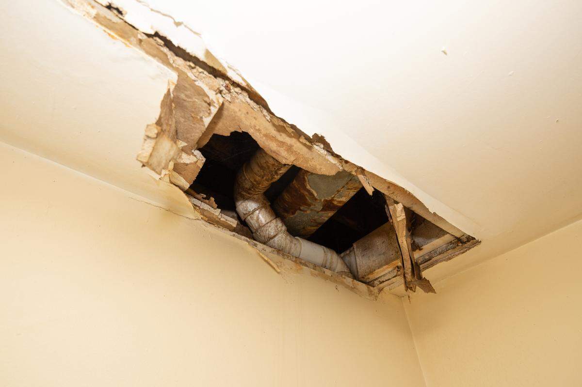 A hole has formed in the ceiling of the utility room inside Tracy Smith and Barry Bagley’s Centreville Courts apartment. “It’s from when the people who lived upstairs had a leak up there and they didn’t even know they had a leak or they knew and didn’t care,” Smith said.