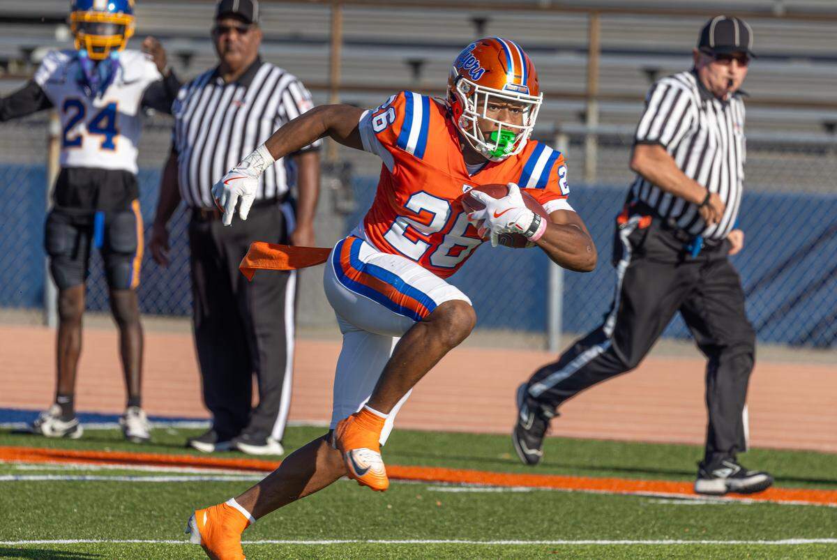 East St. Louis junior Ahmad Coleman turns up field for yardage against Simeon in an IHSA Class 6A football quarterfinal game Saturday.