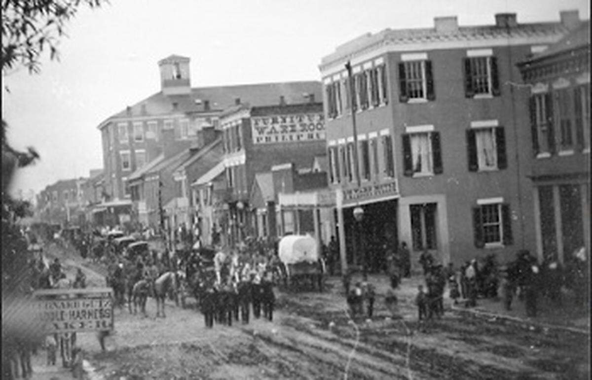 This 1862 photo shows a three-story brick building with a balcony on East Main Street in downtown Belleville during the funeral procession of a Civil War soldier. It was later divided into two addresses. The right half is now being converted into a “boutique” hotel, bar and offices.