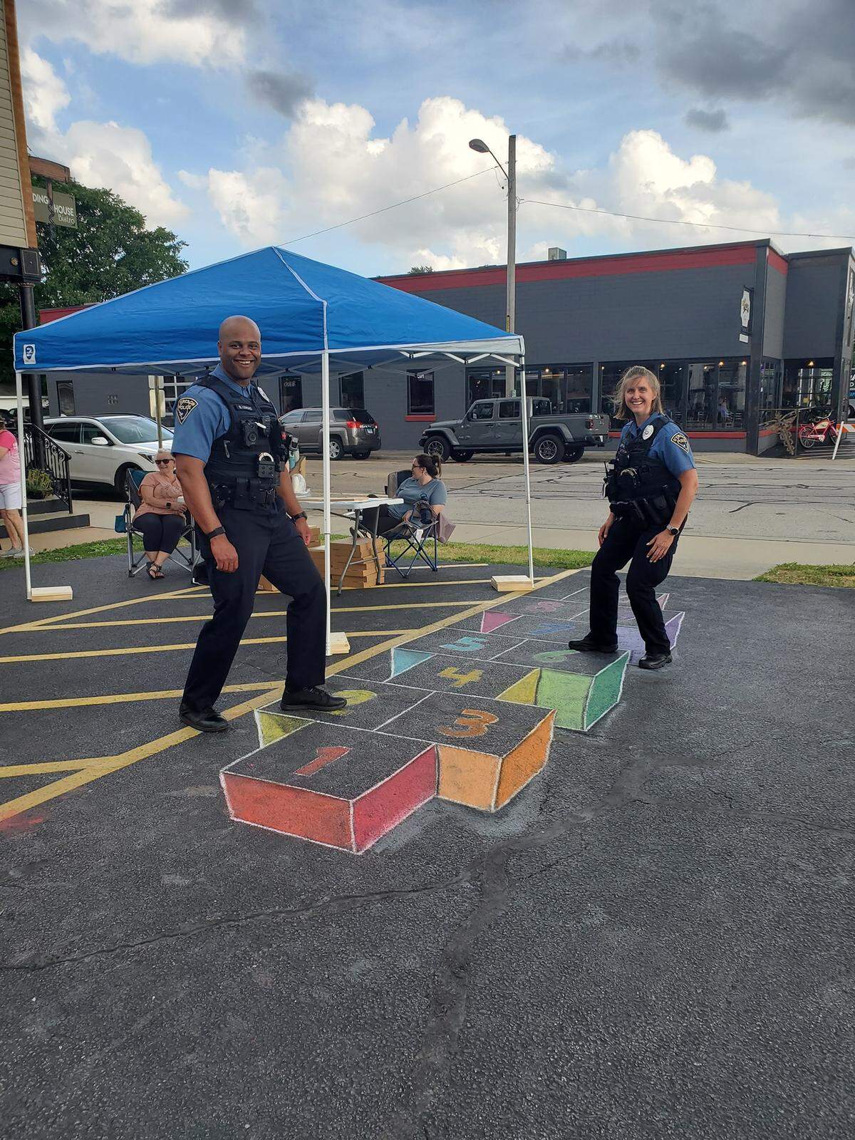 The 3-D hopscotch blocks — the grand prize winner by Maria Knecht — were a big hit at last year’s event. Shown here are O’Fallon Police Officers Bryan Lemons and Detective Kathy Effan.