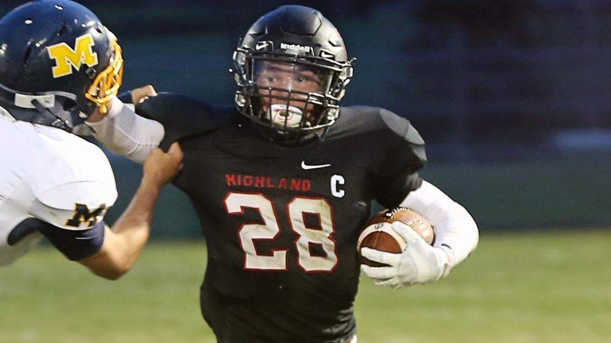 Highland’s Brady Feldmann fights for yards in the Bulldogs’ win over Marion in September.