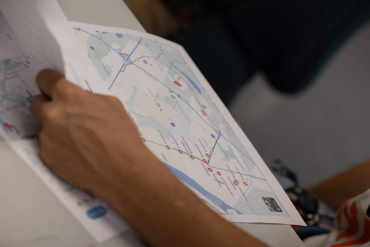 Jalen Williams, from the group Parents United for Change, reviews the bus route.