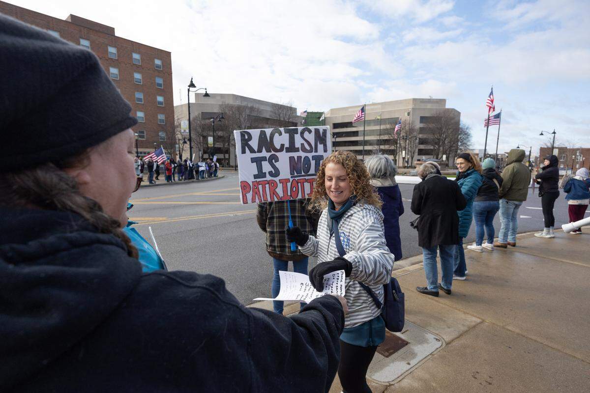 Tracy Webb hands out flyers with the contact information of local representatives during a demonstration at Belleville’s Public Square on Saturday, Jan. 10. “I’m here to stop the killings on our streets,” Webb said. “I just want peace and real change.”