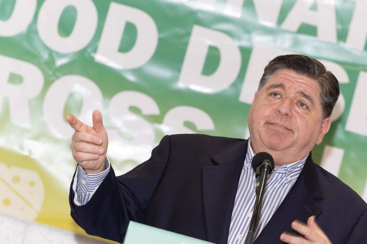 Ill. Gov. J.B. Pritzker makes a joke during a visit to Venice, Ill. for the groundbreaking on a new grocery store.