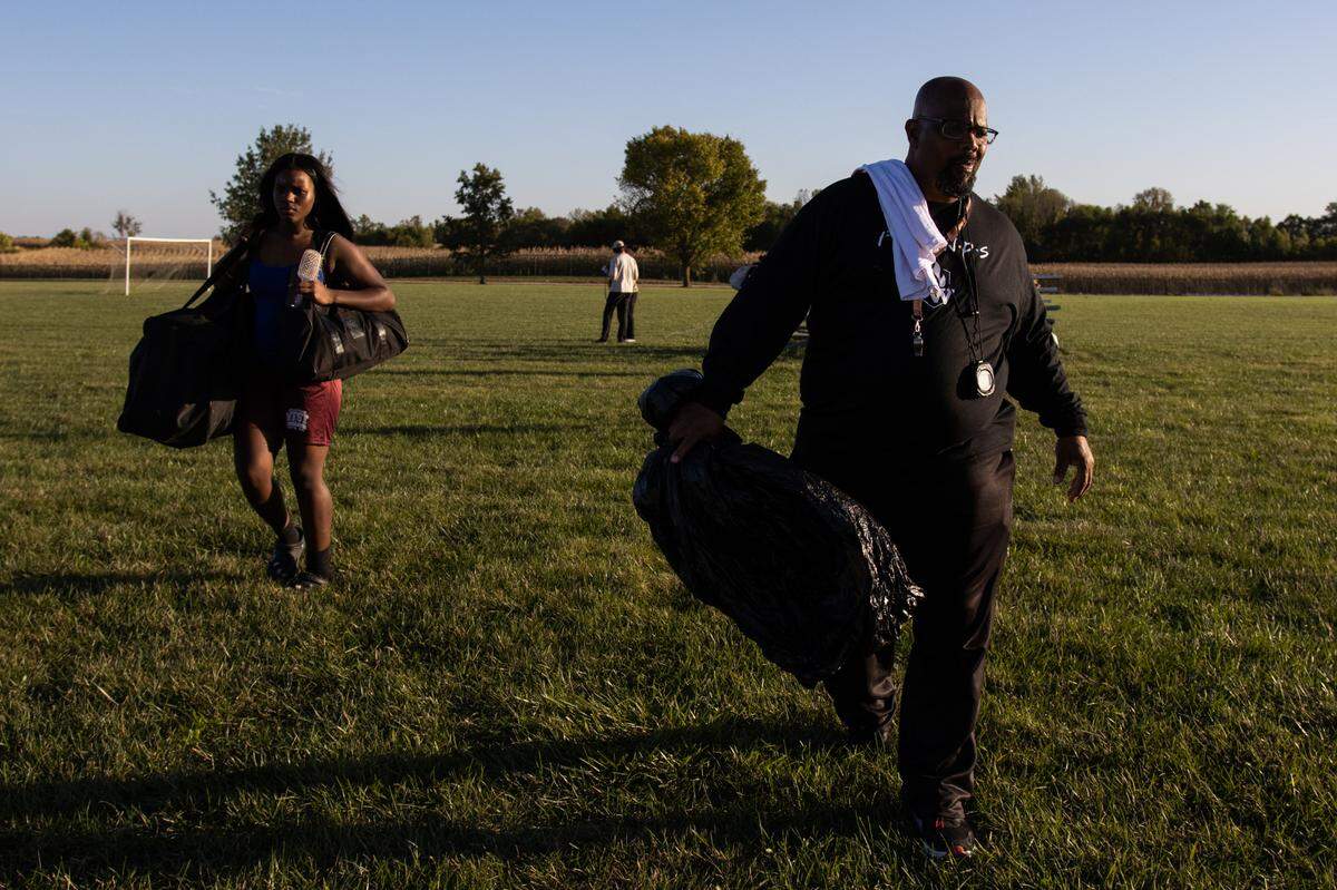 Moriah Lampley and coach Mario Melvin leave a flag football practice on Tuesday at Belleville West High School.
