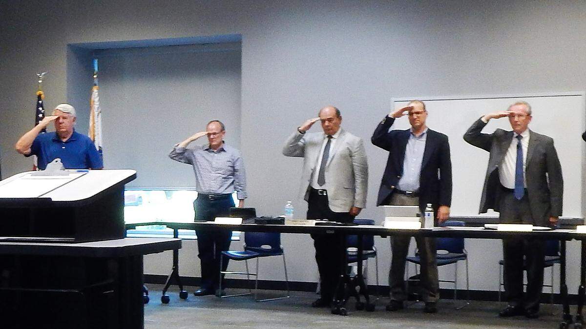 The O'Fallon City Council stood and saluted the veterans.  From left are aldermen Ross Rosenberg, Andrew Lopinot, Courtney Marsh, Richie Meile, Ray Holden and David Cozad; City Clerk Jerry Mouser, City Administrator Walter Denton, Mayor Herb Roach, City Attorney Todd Fleming, and aldermen Jerry Albrecht and Ned Drolet. Not shown, but also saluting, were aldermen Matt Smallheer, Kevin Hagarty and Dan Witt. Aldermen Matthew Gilreath and Mark Morton were not present at the meeting.