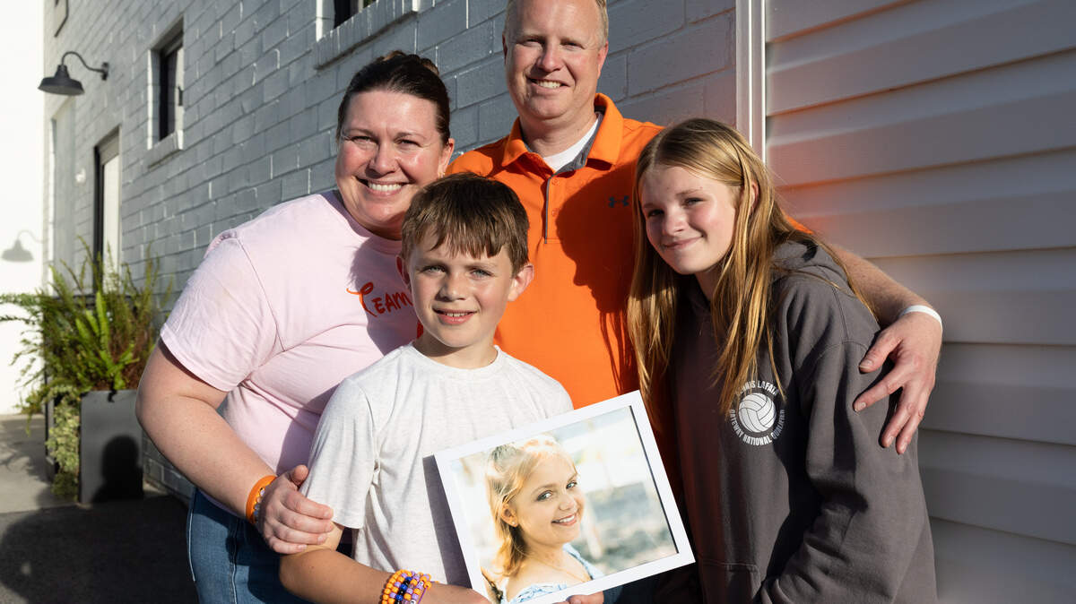 Adrienne, Kevin, Claire and Eli Wiemerslage, the pose outside of Salt & Honey in Waterloo with a portrait of Elsie. Elsie Wiemerslage, 16, died recently after a decade-long battle with cancer. Community members gathered Friday to share memories of the teen and join in the family’s call for stem cell donors. 