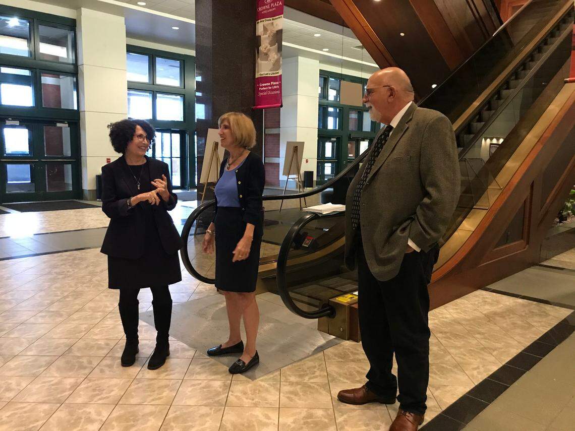 Psychologists Susan Feingold and Diane Sanford celebrate with attorney Jed Stone in the lobby of the Crowne Plaza hotel in Springfield on Oct. 28 after the Illinois Prisoner Review Board voted to grant parole to Paula Sims.