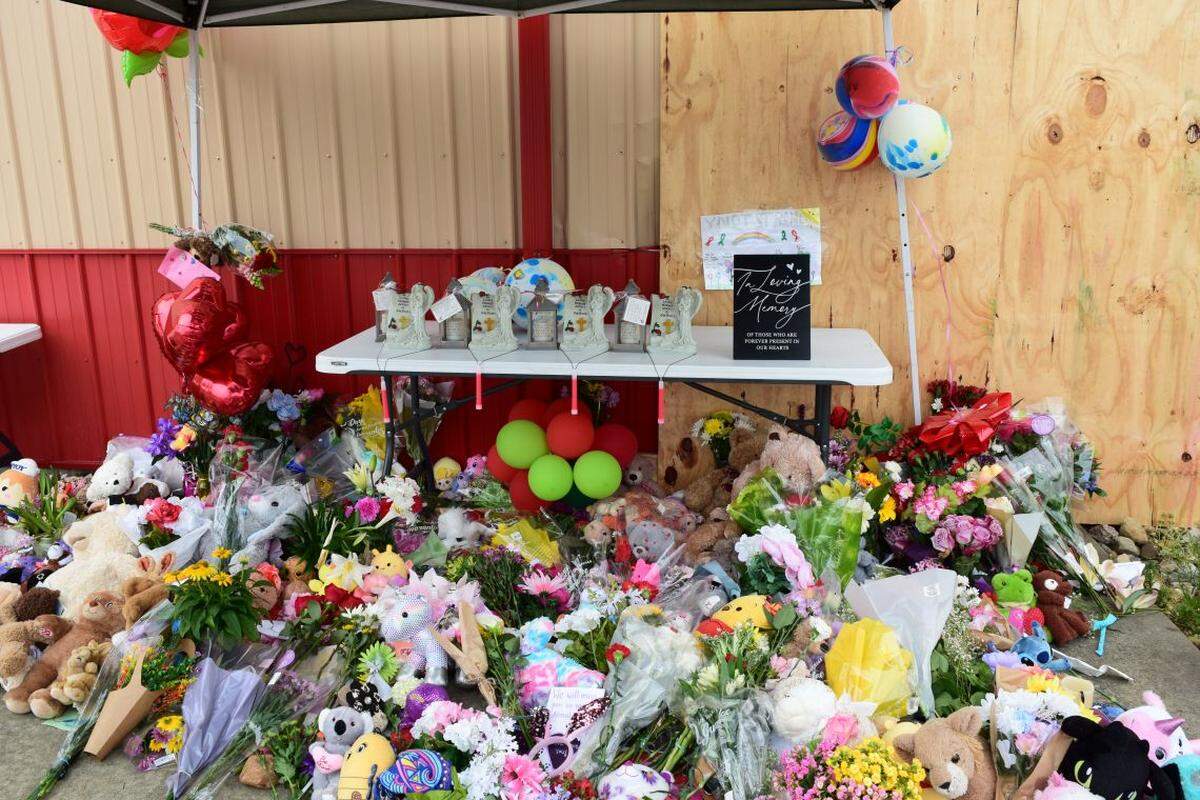A memorial at the site where three children and a teen died when a Jeep crashed through a building that housed an after-school program in Chatham.