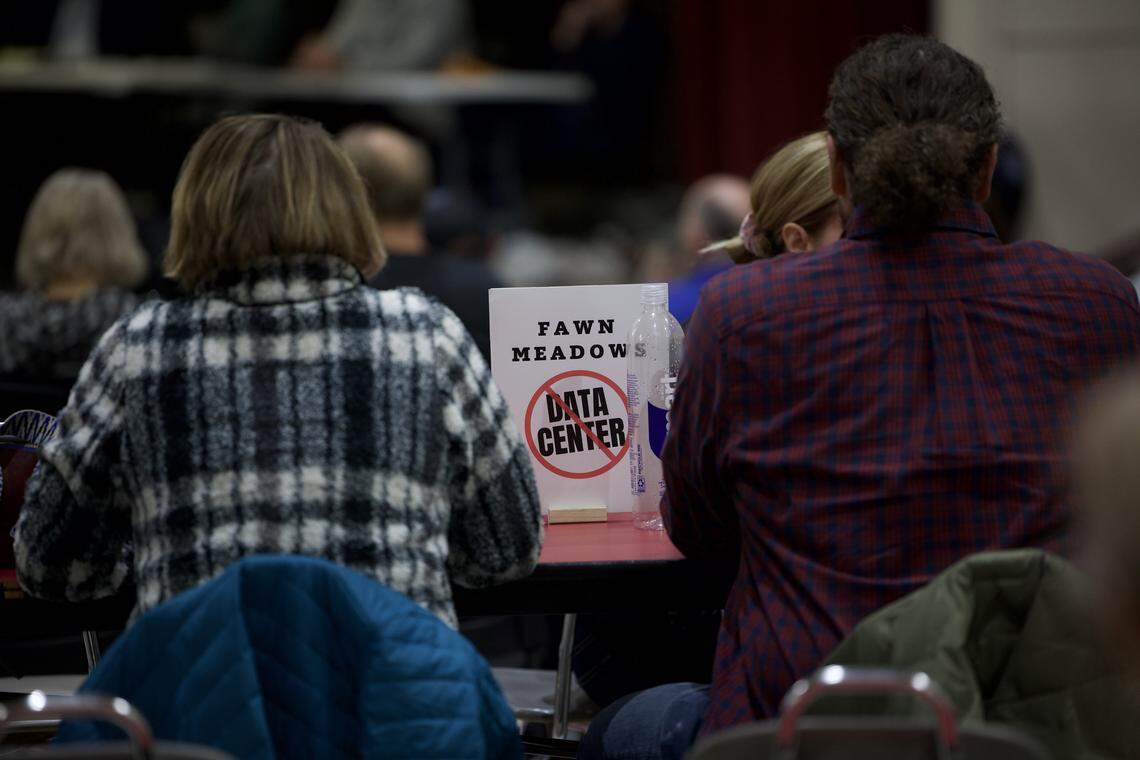 A sign made by residents of Fawn Meadows, a Troy neighborhood adjacent to a potential data center location, shows their opposition during a Feb. 10, 2026, community forum.