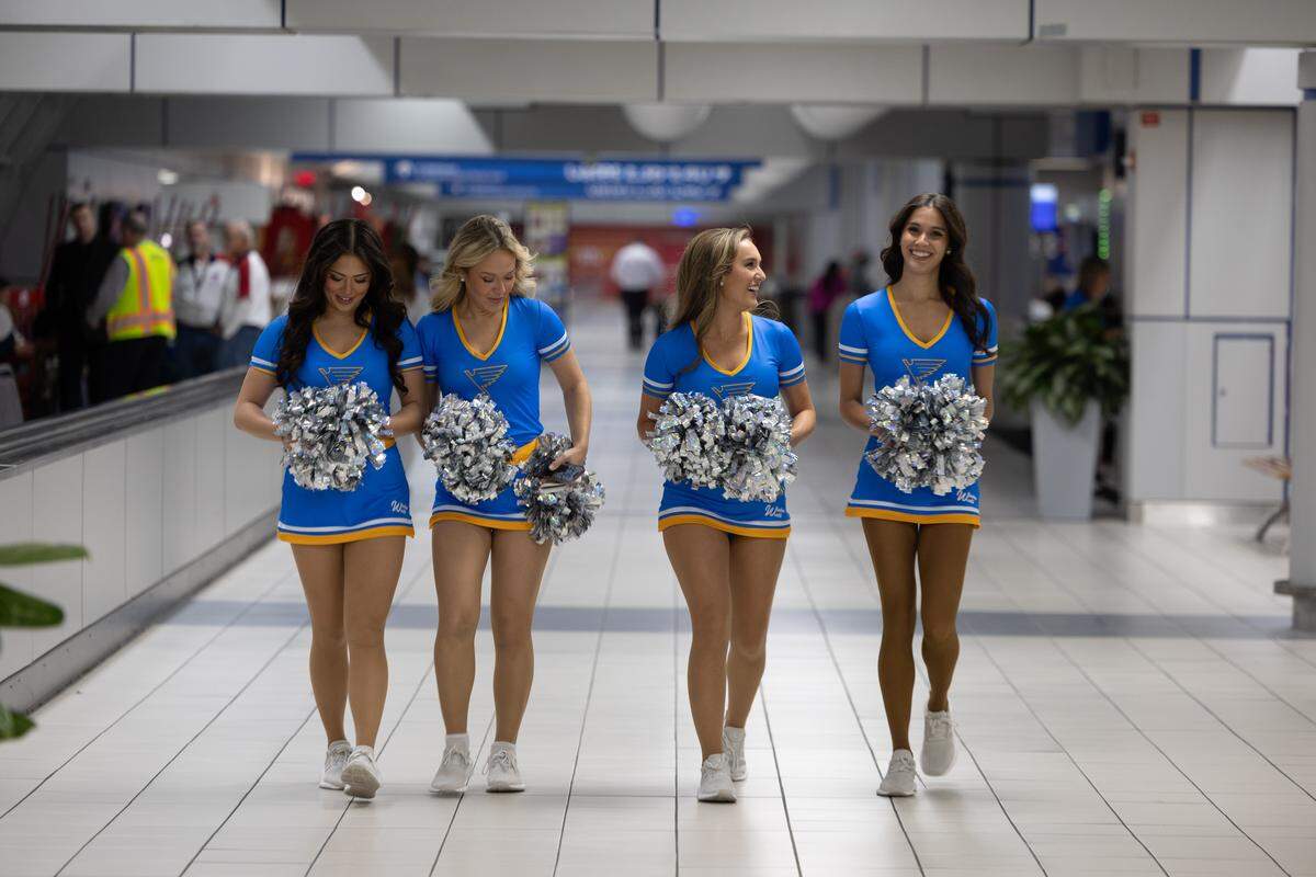 Cheerleaders for the St. Louis Blues traverse Lambert airport to greet veterans as they return from a Greater St. Louis Honor Flight.