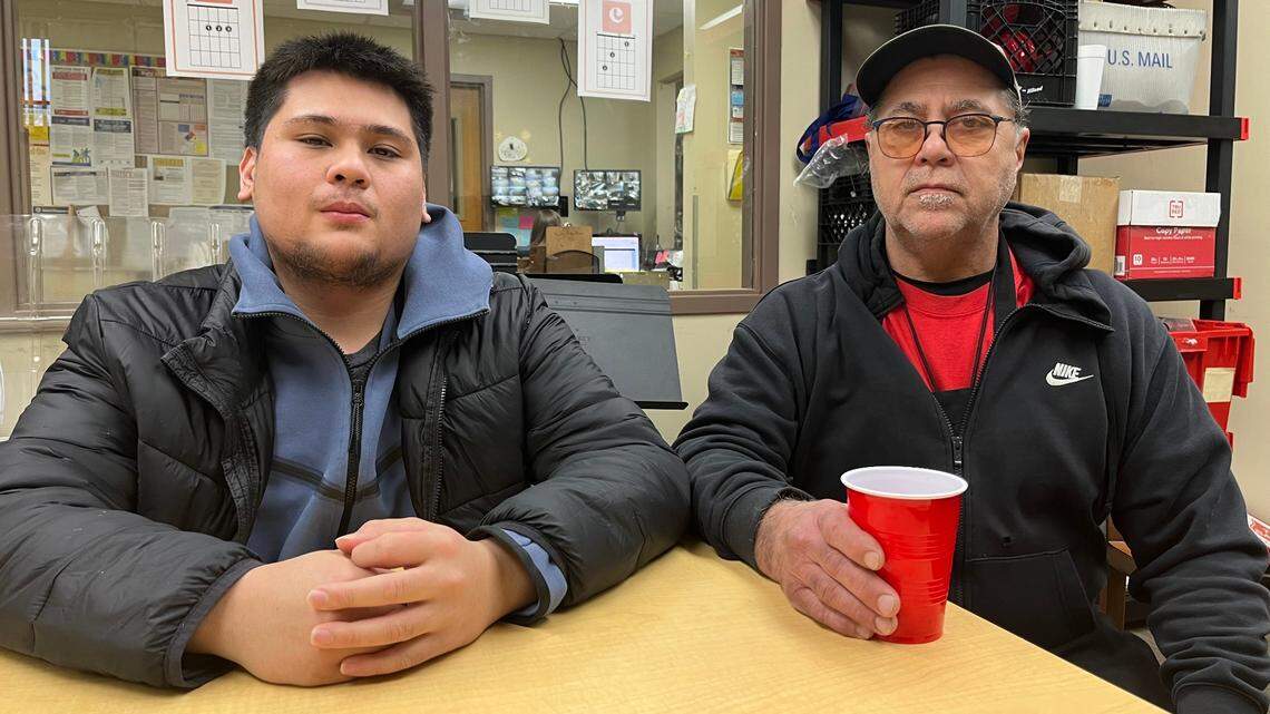 Brandon Rios, left, and his father, Ron Rios, sit in a meeting room at The Salvation Army’s St. Clair County community center, where Ron works as a chef. Brandon survived a shooting at the Belleville MetroLink station on Dec. 23.