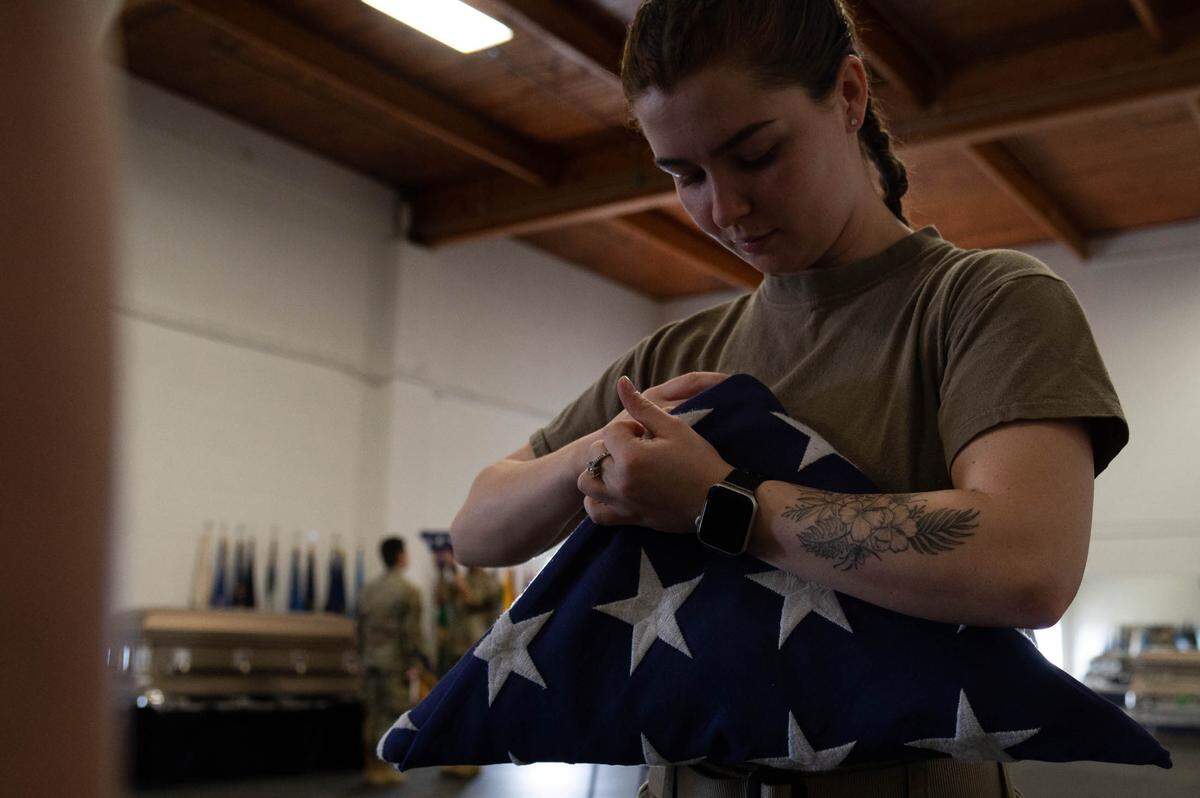 U.S. Air Force Senior Airman Miranda Underwood, 375th Medical Group pharmacy technician, folds an American flag in the fold position for a two-man detail on Scott Air Force Base. The detail preforms a two-man flag fold with the playing of taps to veterans who served in the United States Air Force.