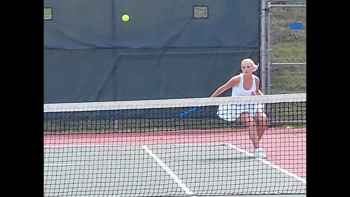 Ruthie Manor of the Highland girls tennis team competes in a match against Triad in the Class 1A sectional No. 2 singles at Althoff Catholic High School in Belleville.