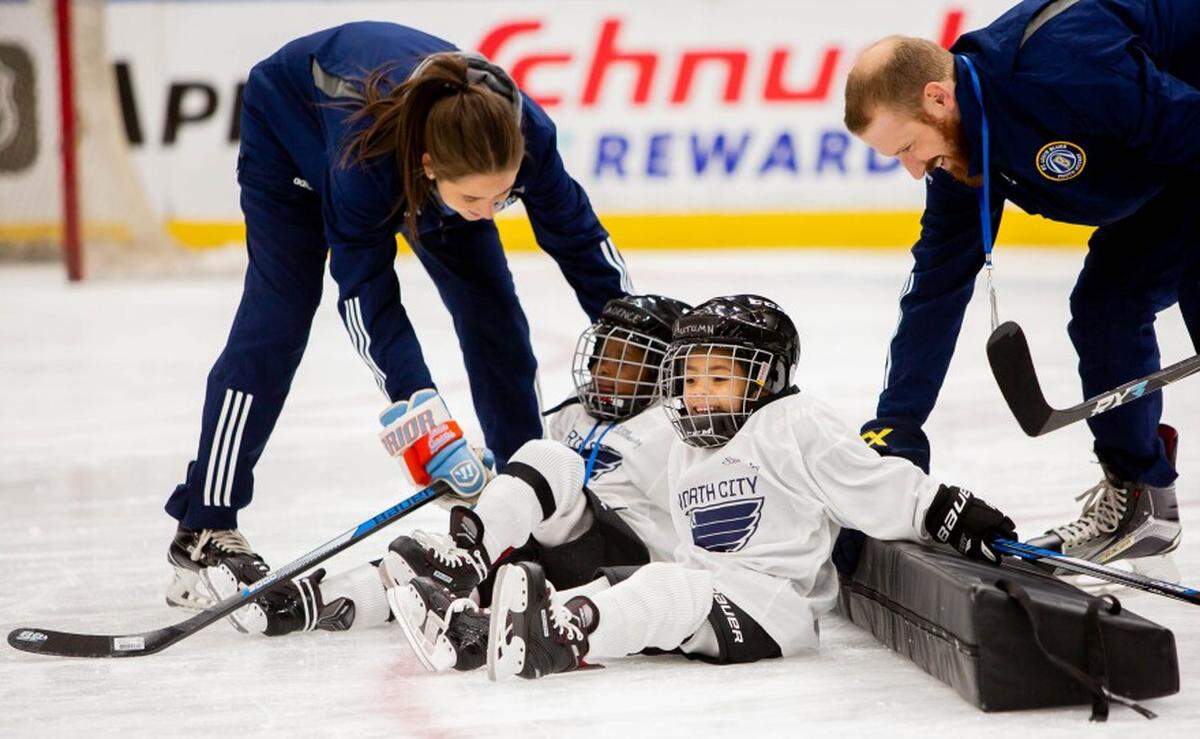 Autumn Leslie, center-right, a 4-year-old from Florissant, gets helped up alongside a classmate after attempting to step over a foam block March 9 during a North City Blues practice at Enterprise Center.