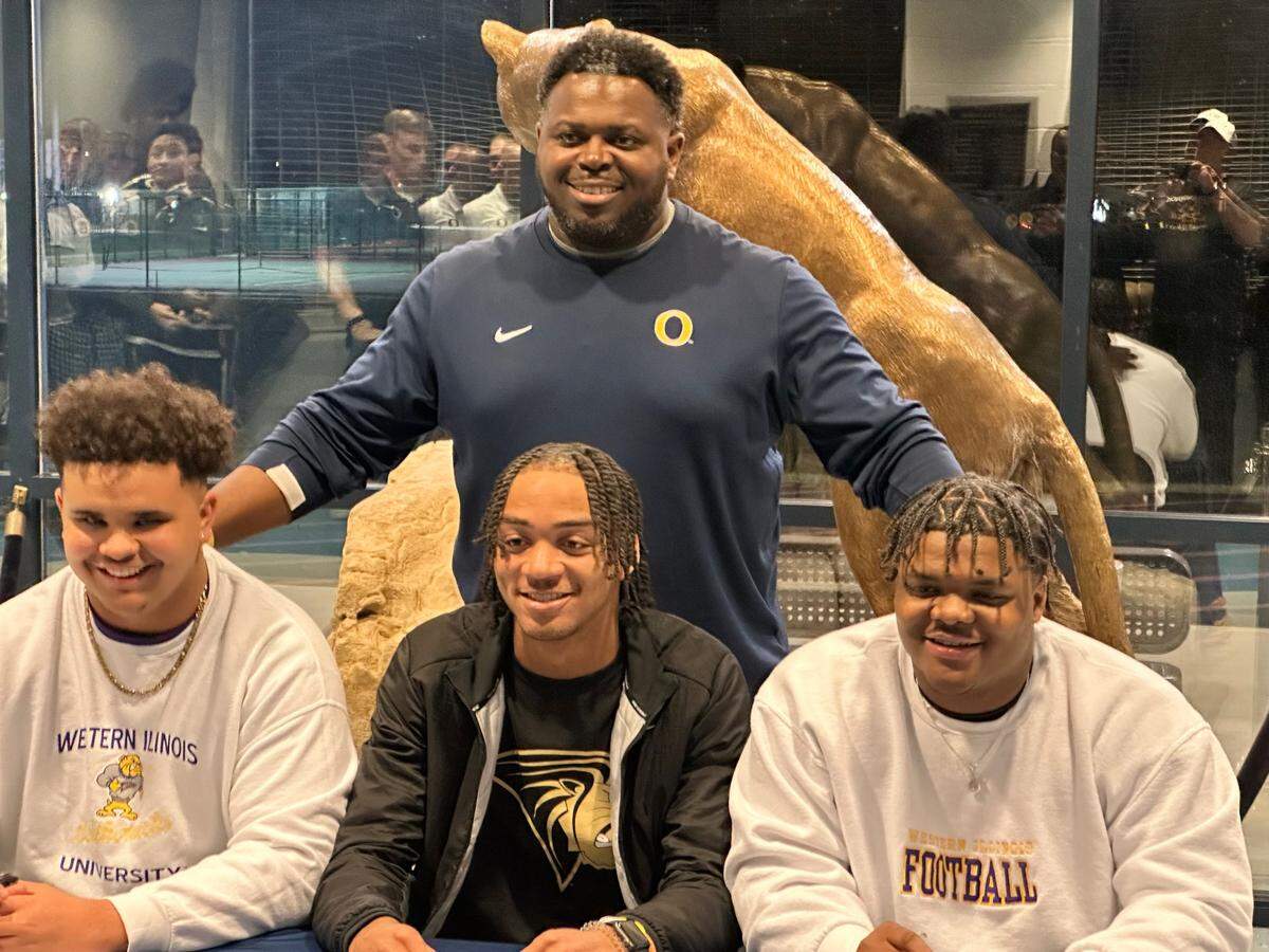 Pictured are O’Fallon High School football standouts who signed their National Letter of Intent on Wednesday, Dec. 21. From left, Marcus Hansen (Western Illinois), Jalen Smith (Lindenwood) and Kaleb Randolph (Western Illinois) and Kaleb Randolph (Western Illinois). Panthers coach Byron Gettis is pictured behind them.