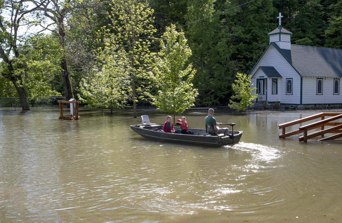 Chautaqua residents use a john boat to make their way to their home. Mississippi river levels are receding in the small community located on the river road north of Alton. About 12 households are forced to boat back and forth to their homes when the water is at the current levels.
