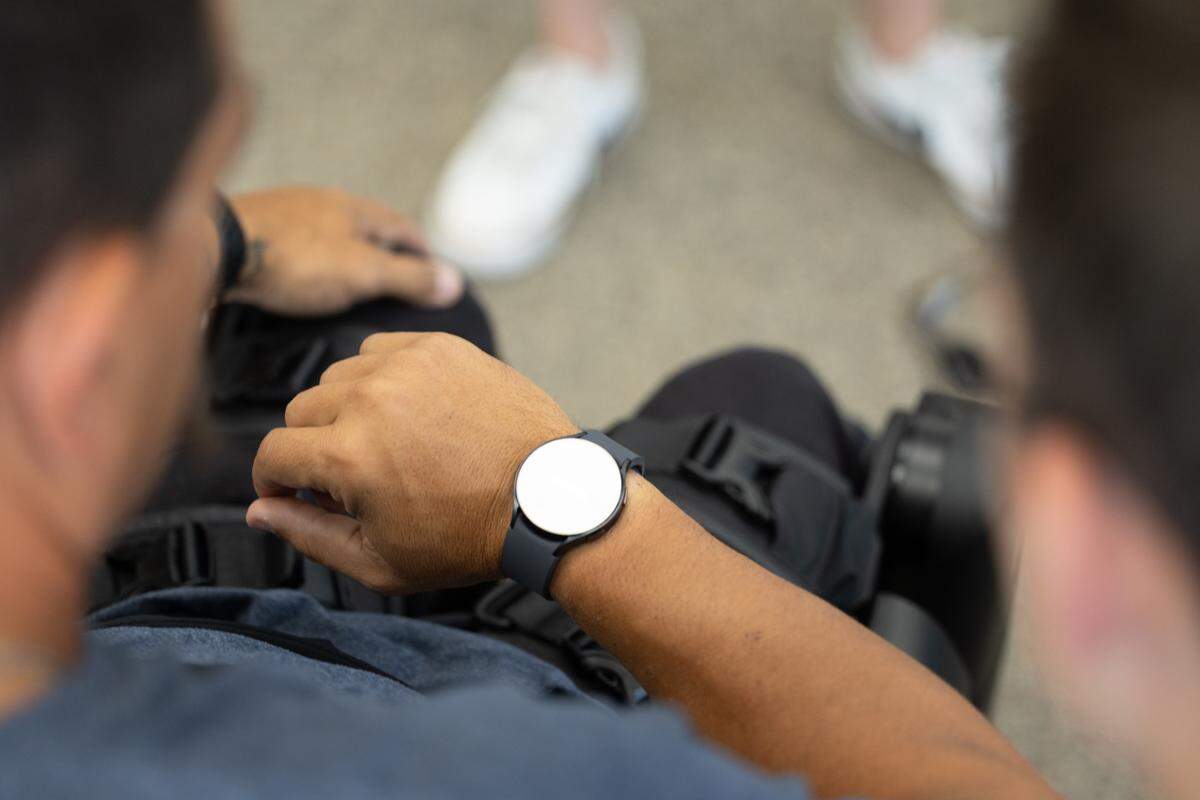 Brad Henke opens up the ReWalk app on his smart watch that allows him to use his exoskeleton legs. Should the watch fail or glitch, there are also controls on his electronic cane and his phone.