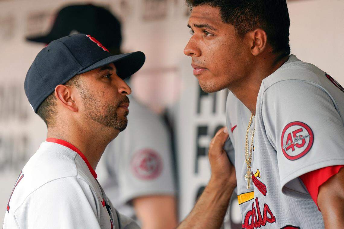 St. Louis Cardinals manager Oliver Marmol, then a bench coach, talks to starting pitcher Johan Oviedo during a game in Cincinnati last July. The organization has called up prized prospect Zack Thompson and Marmol said the club was comfortable with the possibility of the southpaw finding a short-term home in the bullpen given the success of other pitchers who have followed that path.