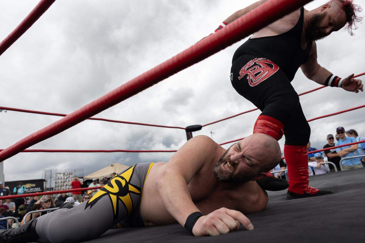 Belleville, Ill. based professional wrestler Bobby D stomps on the head of “Superstar” Steve Fender during the first day of the Enjoy Illinois 300 Cup Race at WorldWide Technology Raceway in Madison, Ill. on June 1, 2024.
