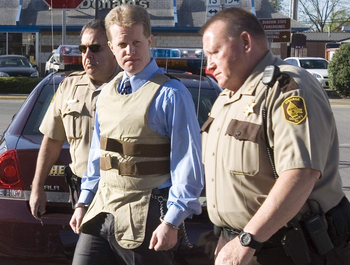 Chris Coleman is escorted into the Perry County Courthouse in 2011. Coleman was convicted in the strangulation death of his wife, Sheri, 31, and their two children, Garett and Gavin.