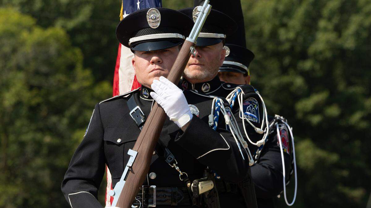 Honor guard consisting of members of Belleville police and fire departments present colors during a 9/11 remembrance ceremony along the 9/11 Memorial Walkway at Belleville firehouse #4.
