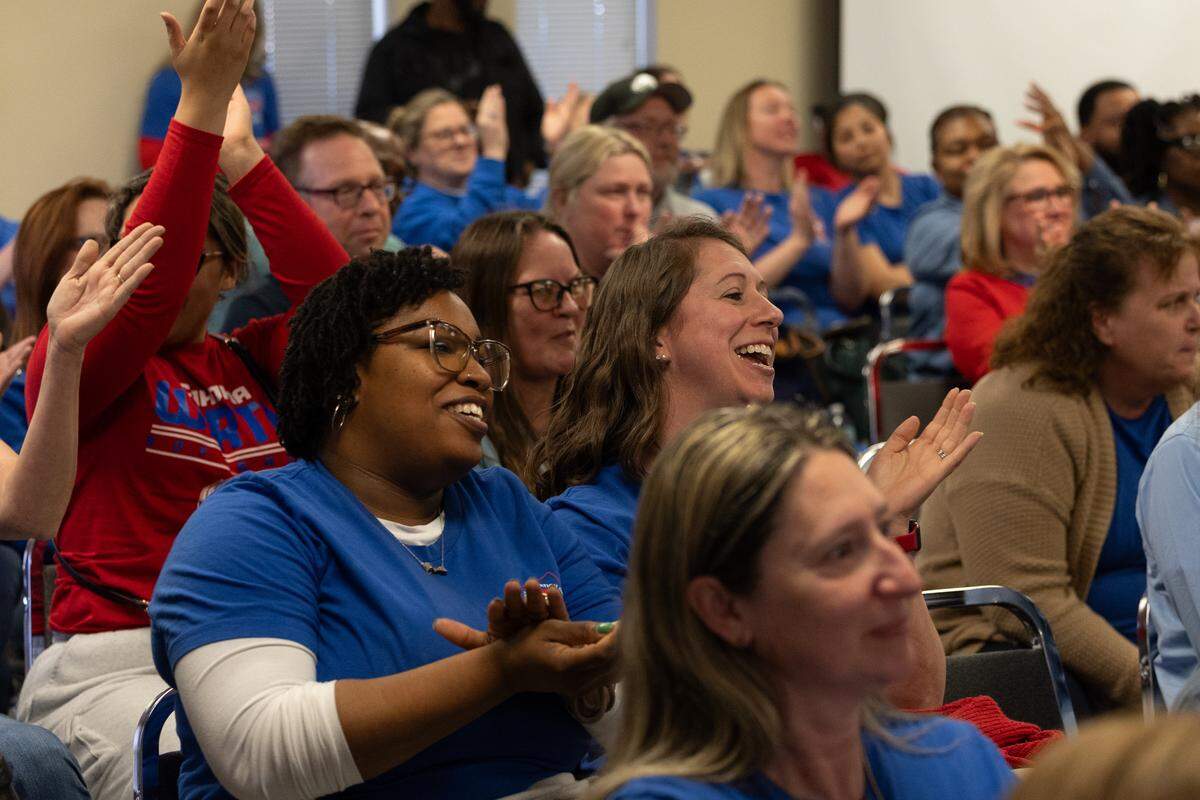 Members of the Cahokia Federation of Teachers Local 1272 cheer after union leader Ray Roskos rips up a statement sent by Cahokia Heights superintendent Curtis McCall Jr.