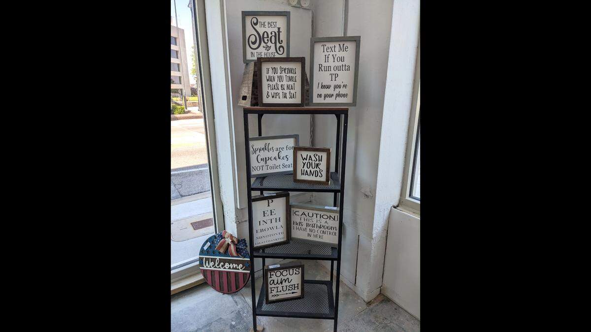 Painted wood signs at Sawdust & Glitter in Belleville come in different themes.