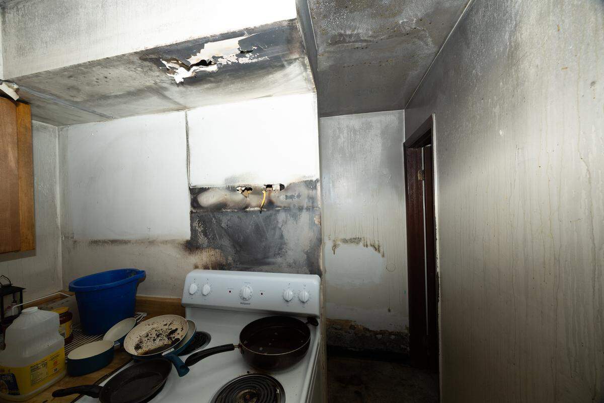 Three months after a fire, Greystone Apartments tenant Andrea Polk’s kitchen is still coated with black soot. “How the kitchen is looking makes me not want to be in here,” said Polk, a mother of five.