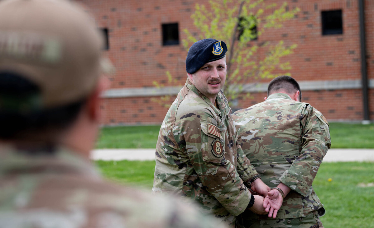 U.S. Air Force Staff Sgt. Nathan Polzin, 375th the 375th Security Forces Squadron trainer, instructs detaining tactics during an Agile Base Defense Course training block on Scott Air Force Base. Instructors focused on combat readiness and security forces tactics during the exercise.