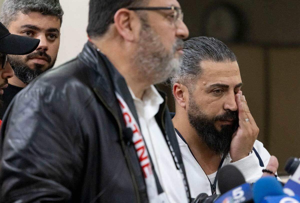 Oday Al-Fayoume, right, the father of Wadea Al-Fayoume, rubs his face while Wadea’s uncle Yousef Hannon speaks at the Muslim Community Center on Sunday, Oct. 15, 2023, about the stabbing death of 6-year-old Wadea in an anti-Muslim hate crime, according to the Will County sheriff’s office and the family’s relatives. (Brian Cassella/Chicago Tribune via AP)