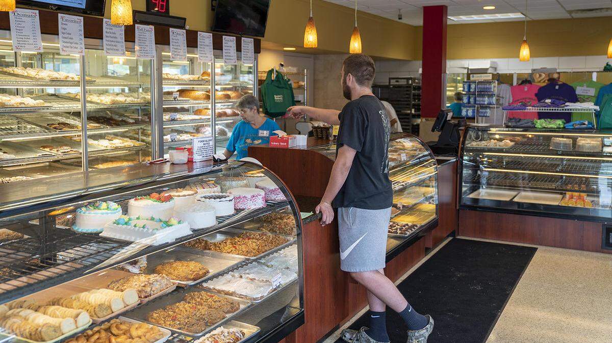 A customer at Kruta’s Bakery in Collinsville selects a pastry Aug. 13. Kruta’s is celebrating its 100th year as a family-owned business.