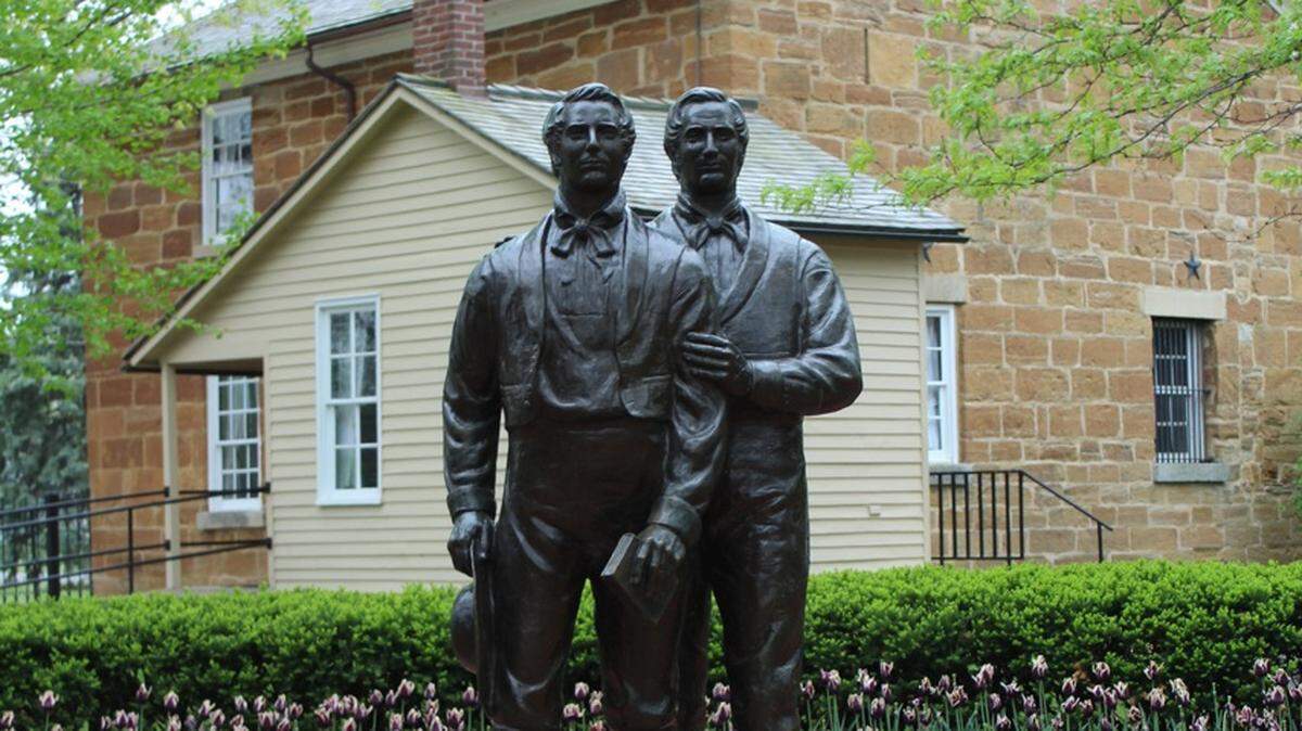 A statue of Joseph Smith and his brother Hyrum stands outside the Carthage Jail where the two were killed in 1844. The historic jail is still open for tours.